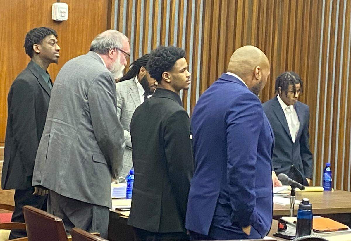 Standing as the jury enters the courtroom are, left to right, defendant Corey Troupe, attorneys Mark Shelnutt and William Kendrick, defendant Jahiem Davis, attorney Shawn Hoover, and defendant Davion Dupas.