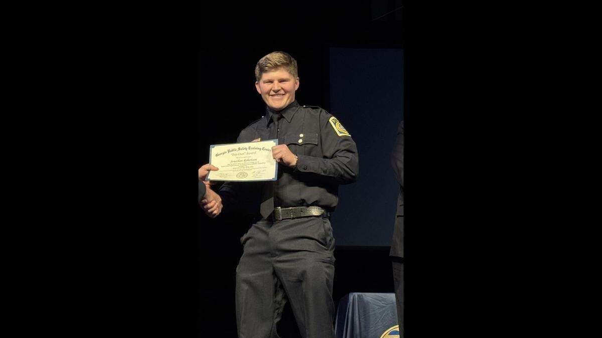 Columbus police Officer Jonathan Robertson is presented the “Top Gun” award during a graduation ceremony in December 2024. 