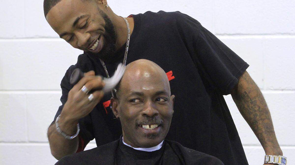 Photos by Mike Haskey/mhaskey@ledger-enquirer.comAntoine Fisher, a barber at Prime Time Barbershop at 1656 South Lumpkin Road in Columbus, gives a haircut Friday morning to Joshua Williams at the Open Door Community House during the 2016 Project Homeless Connect.