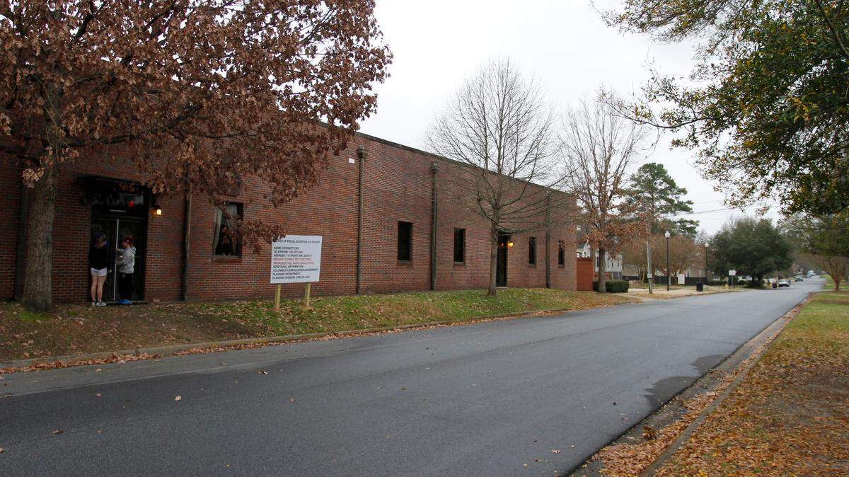 People enter Crossfit CSG on Tuesday, Feb. 19, 2019, in Columbus, Ga. There is a sign in front of Crossfit CSG regarding a special exception use request.