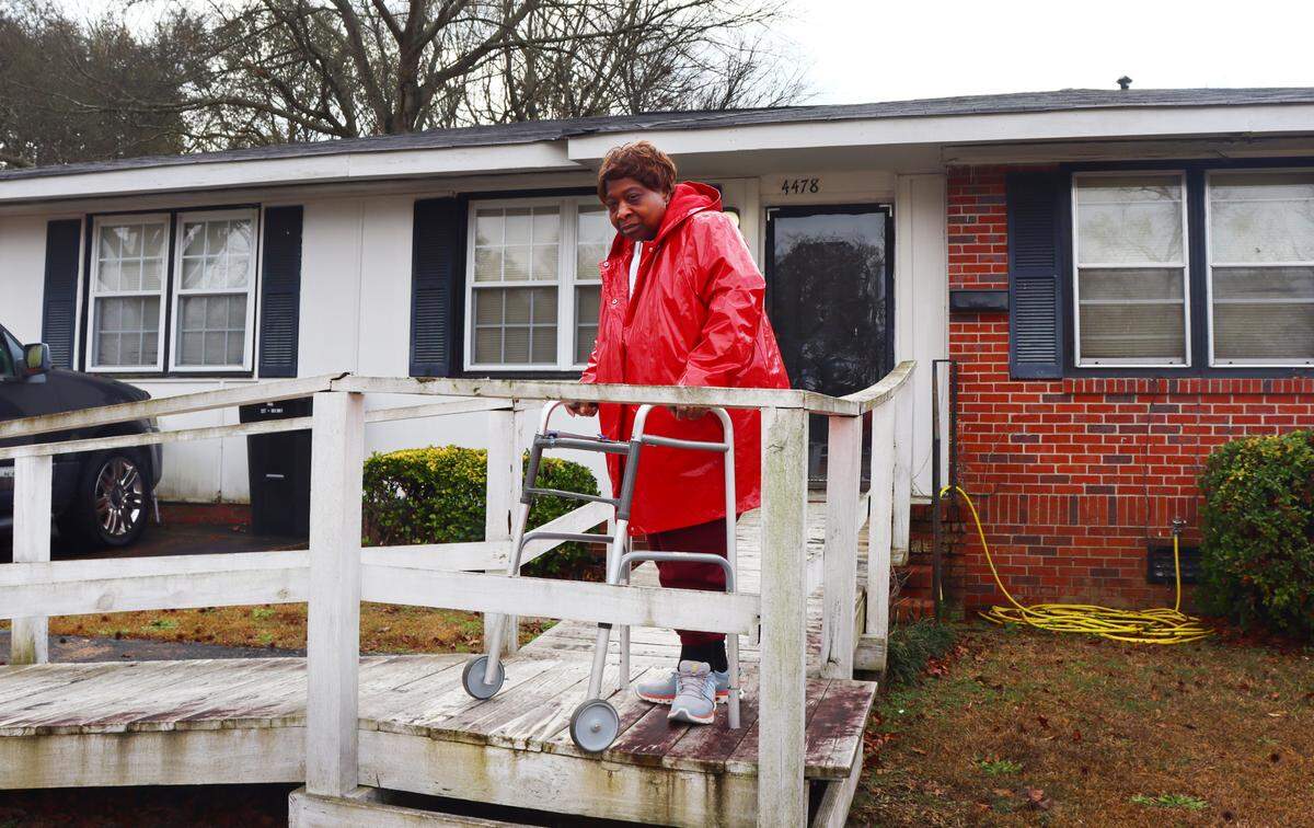Vivian Nelson,70, stands in front of her house in Columbus, Georgia. Nelson’s broken A/C and heater were fixed for free through the weatherization program in early January. 1/16/2024.