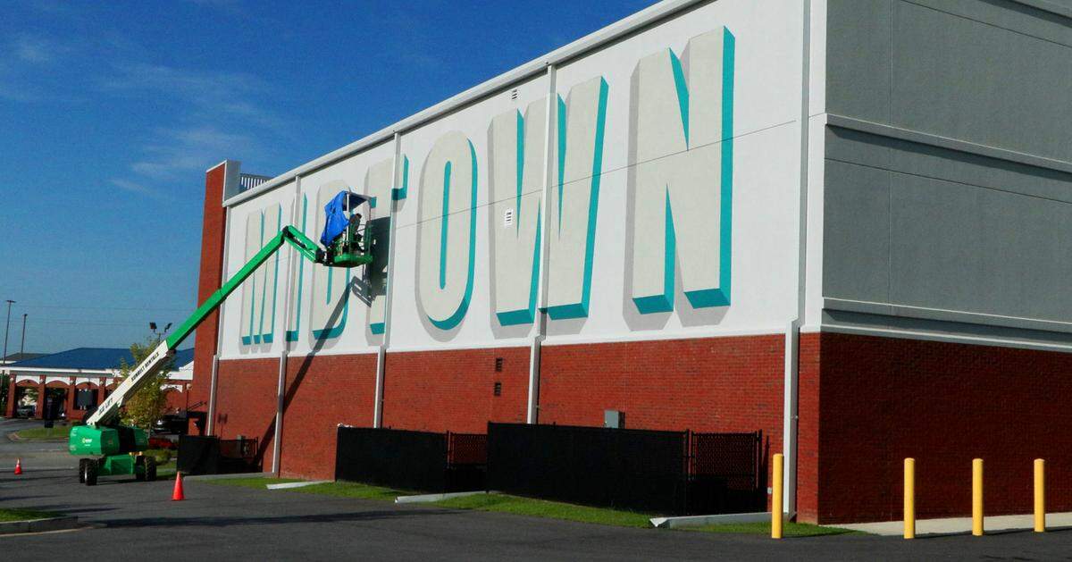 Artists Chris Johnson and Michael Burke begin painting a new mural on Extra Space Storage at Cross Country Plaza in midtown Columbus on July 14, 2025.