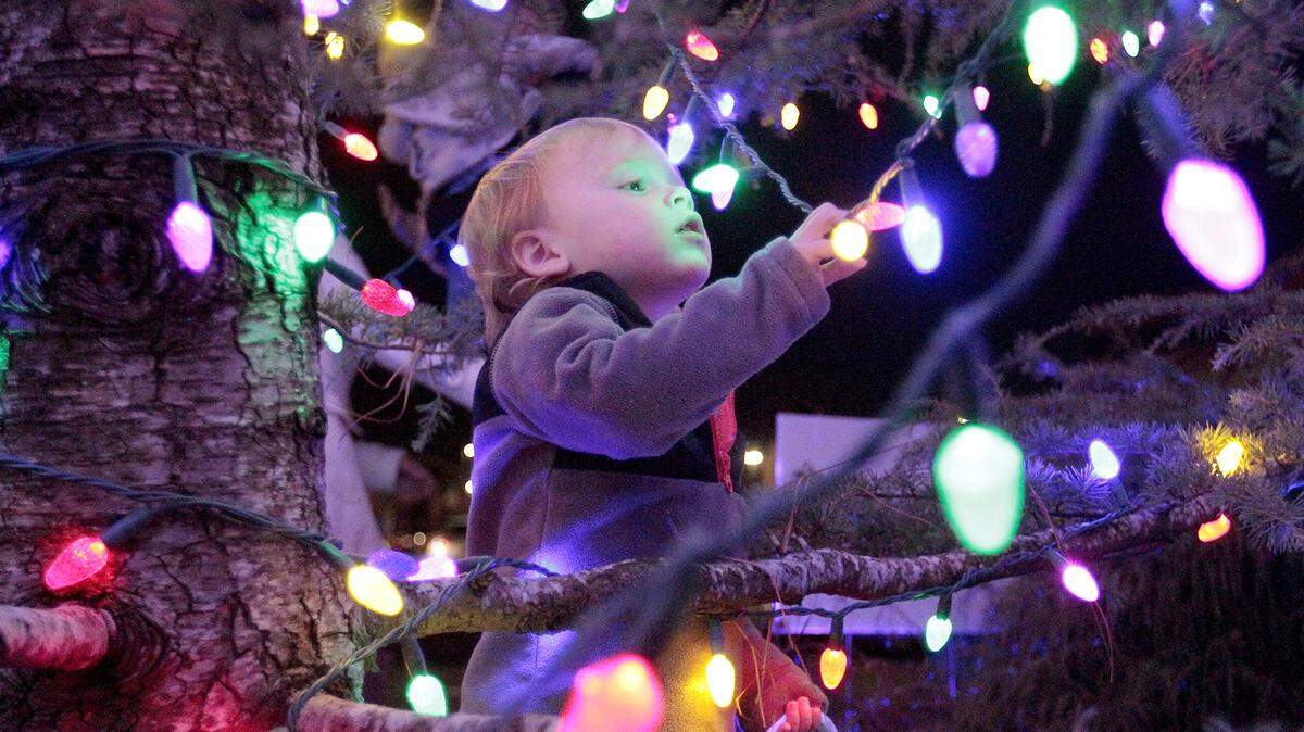 Lincoln Coley, 2, explores inside the Christmas tree during the Tree of Light & Celebration of Life at Piedmont Columbus Regional Midtown Campus on Dec. 26, 2018.