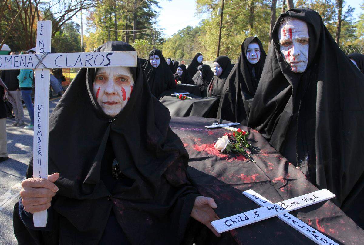 Protesters participating in the mock funeral procession wait to begin their march Nov. 22, 2015, during the SOA Watch protest at the gates of Fort Benning.