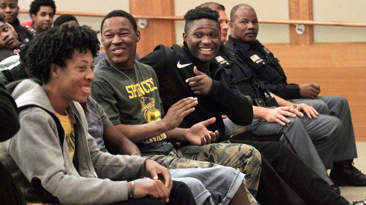 ROBIN TRIMARCHI/rtrimarchi@ledger-enquirer.comSpencer High football players Robert Murray, center right, and Dayquon Thornton, center left, respond to a teammate during a question-and-answer session with Columbus Police Department officers at the Columbus Library on Saturday.