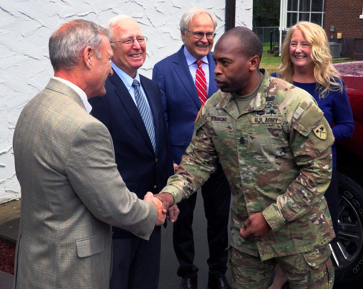Command Sgt. Major Kenyon Simmons, right, greets from left, Dave Moore, Steve Moore, Greg Moore, and Cecile Moore Rainey. 02/17/2023