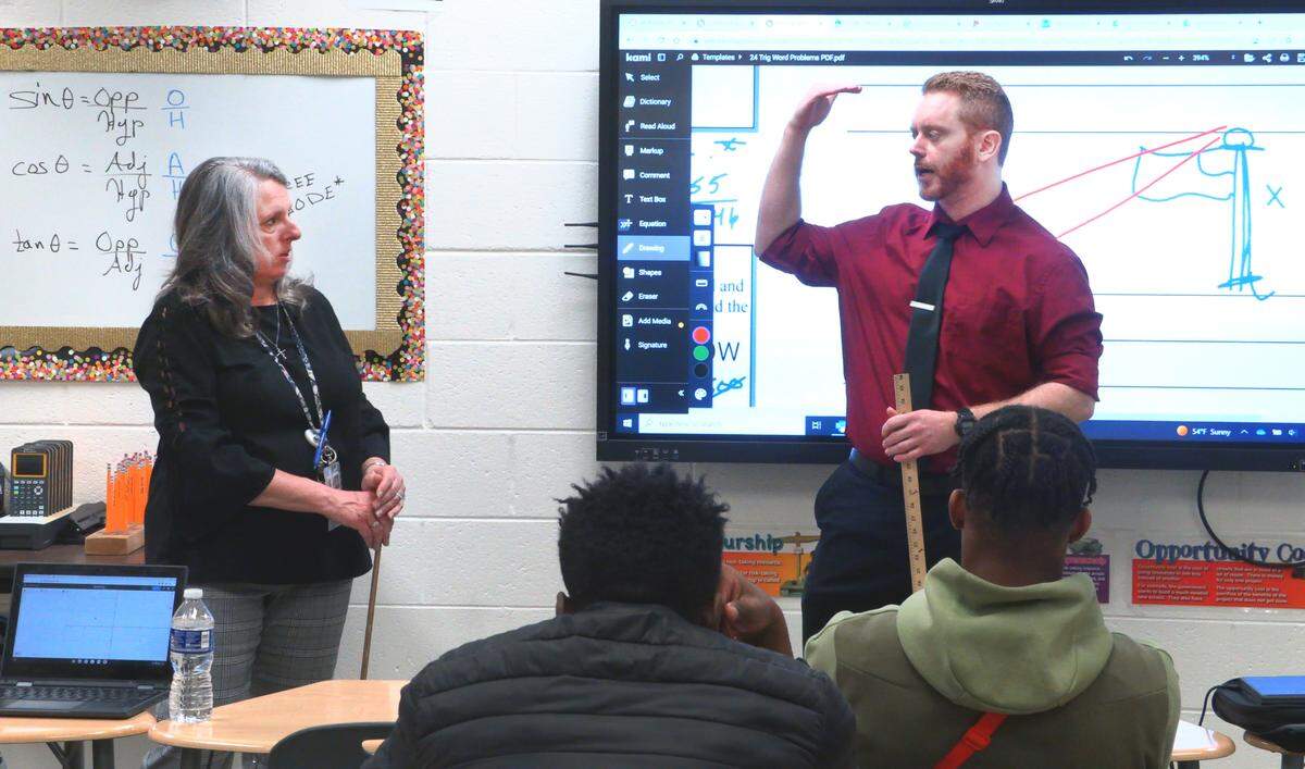 Paige Garrett, left, a learning support specialist teacher at Hardaway High School, teaches a geometry class alongside fellow Hardaway teacher Joshua Alsup.