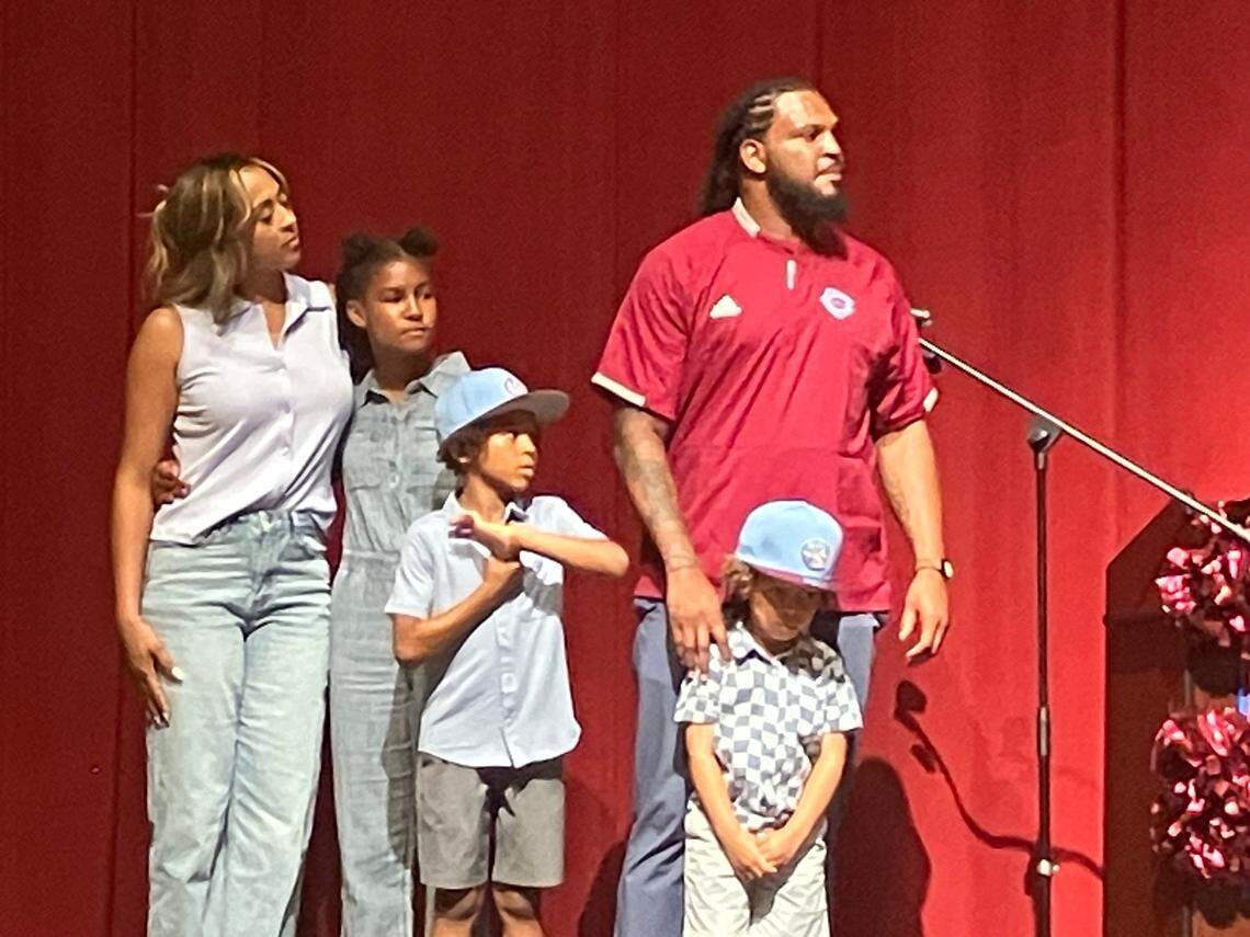 Jarvis Jones and family members stand on stage May 25, 2025, in the Carver High School auditorium, where he was announced as Carver’s new head football coach.
