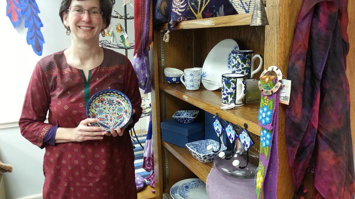 LARRY GIERER/lgierer@ledger-enquirer.comSerena Sato, marketing director for the nonprofit SERRV International, shows off merchandise during a visit to Columbus.
