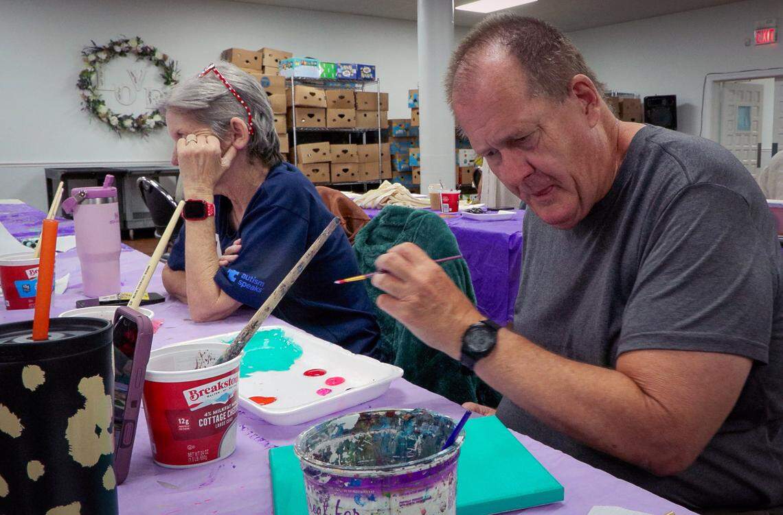 Robert Anthony, right, works on a painting during the April 23, 206, session of the “Home Is Where The Art Is” program in Columbus at Second Baptist Church.