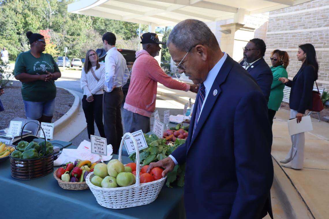 Georgia Rep. Sanford Bishop touches tomatoes from the Food Mill after speaking at Valley Healthcare in Columbus, Georgia on Oct. 22 to talk about the Fresh Food Act that he supports along with Sen. Jon Ossoff