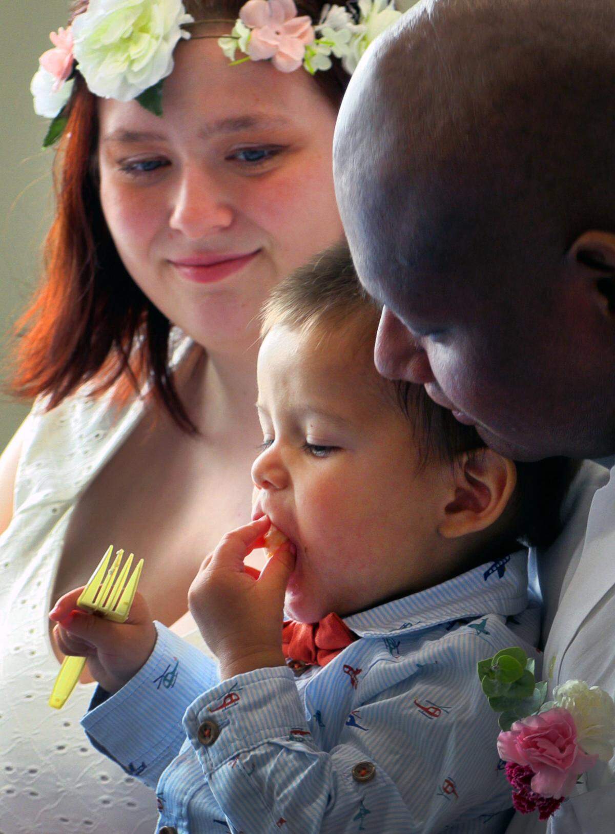 Alexander Santos, his wife Heather, and their two-year-old son Noah eat wedding cake after the couple was married at Piedmont Columbus Regional’s Midtown Campus Wednesday afternoon. 07/20/2023