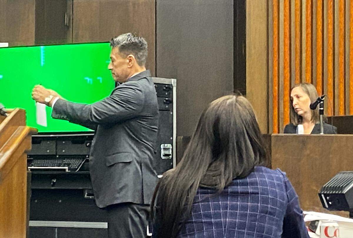 Attorney Allen Jones shows jurors a photograph during firearms expert Catherine Jordan’s testimony.