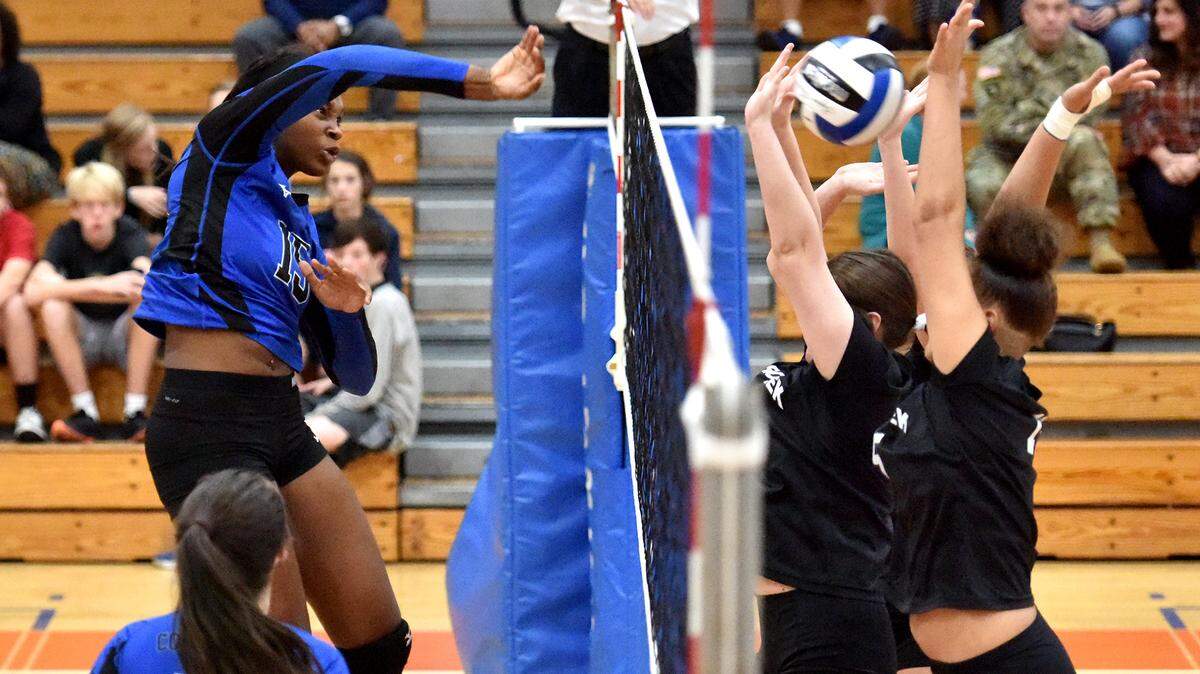 Columbus’ Tierra White delivers a kill past Cross Creek defenders during their Georgia Class AAAA volleyball Sweet 16 state playoff match Wednesday, October 24, 2018, at Columbus High School.
