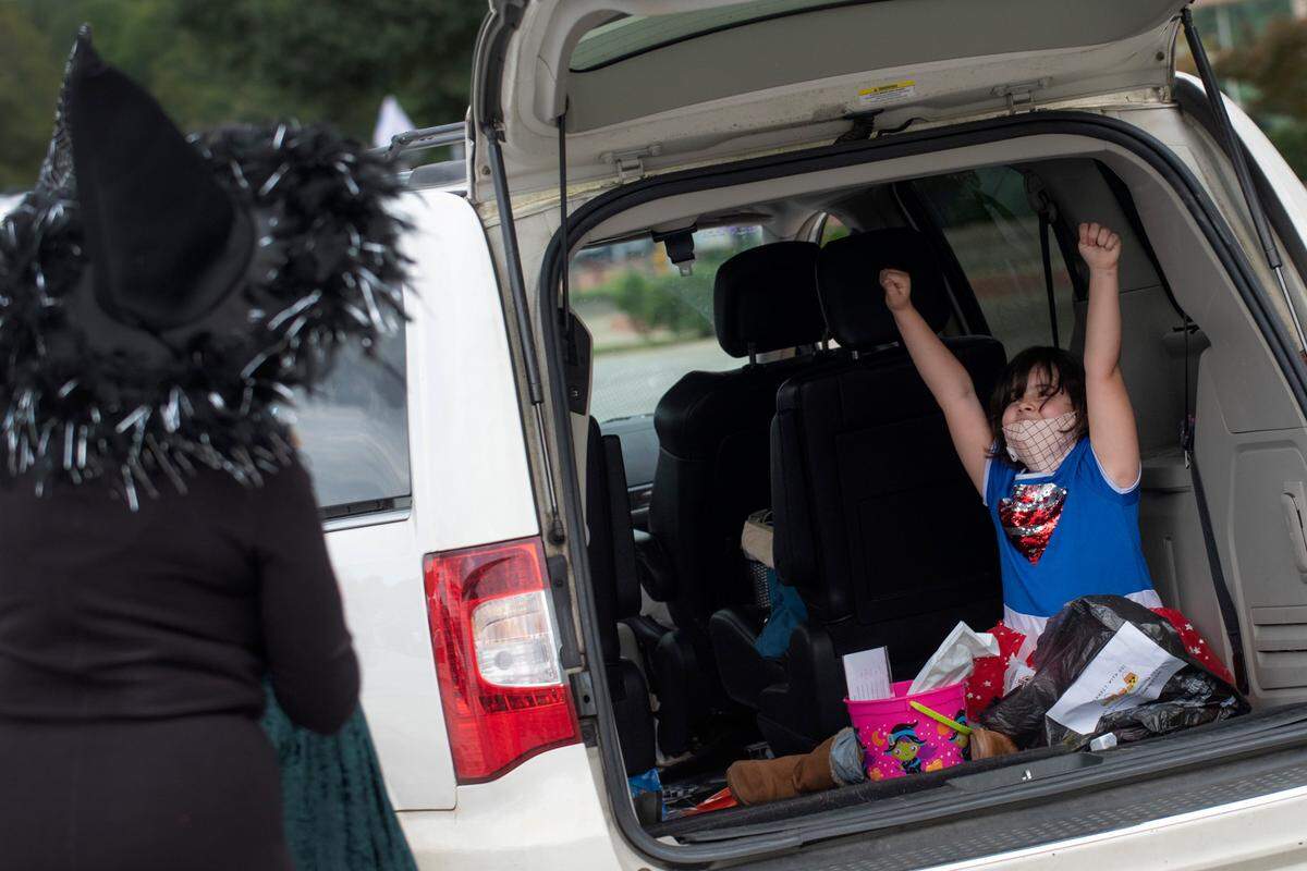 Kadence Parker, 8, from Columbus flashes her Supergirl shirt for dozens of volunteers at the Spooktacular Trunk or Treat event on Sunday, Oct. 25, 2020 at the Civic Center in Columbus.