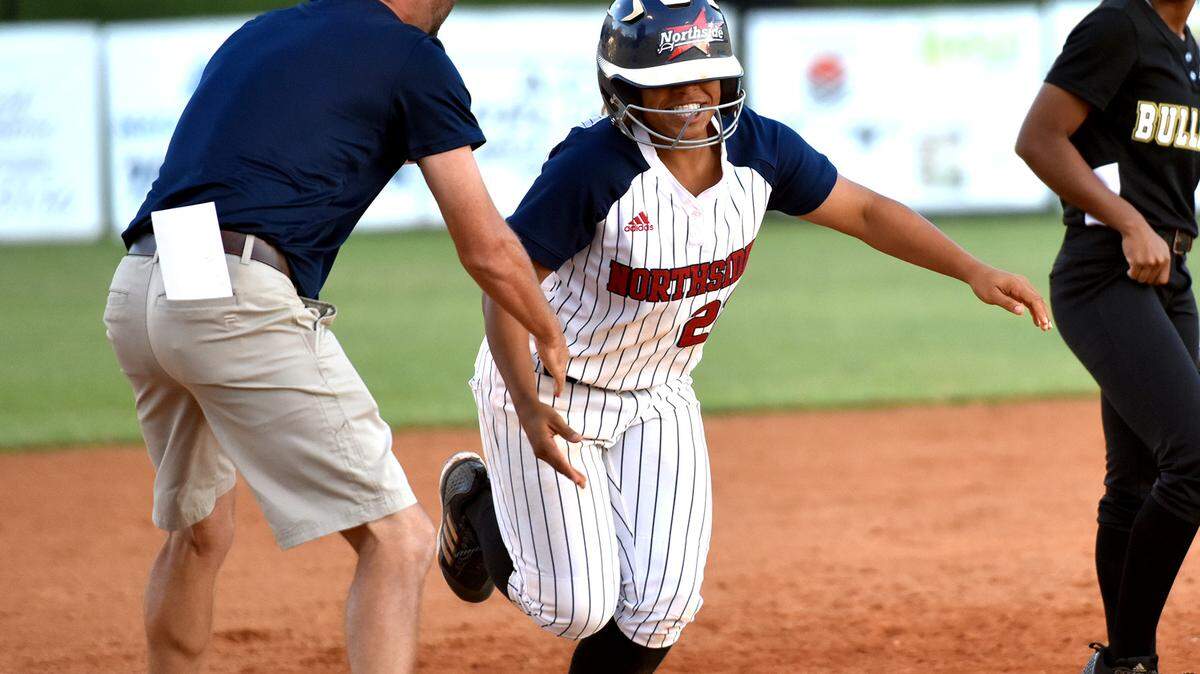 Northside head coach Brandon Jenkins congratulates Jada Chadwick as she rounds third base after hitting a walk-off three-run homer in the final inning to break a 2-2 tie and win Game 1 of the best-of-three second-round series in the Georgia Class AAAA state playoffs  against Mary Persons on Thursday October 18, 2018.