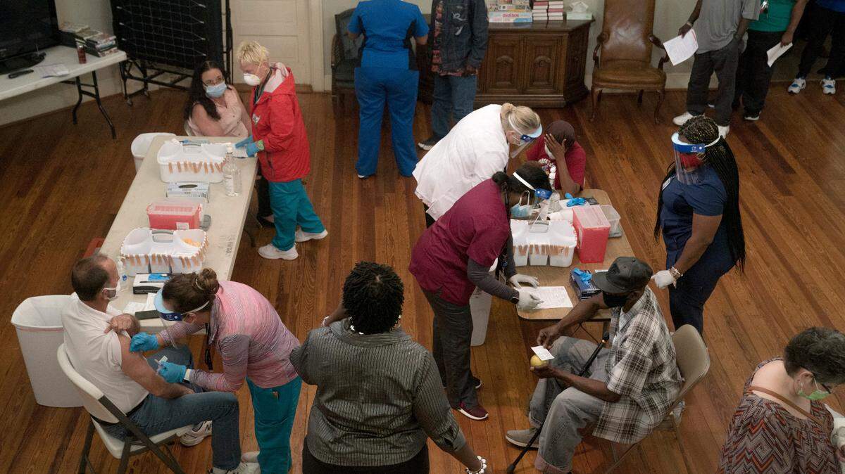 Healthcare workers from the Columbus Department of Public Health vaccinate on Thursday, April 8, 2021 at Safehouse Ministries in Columbus, Ga. The community center vaccinated its support staff and clients experiencing homelessness.