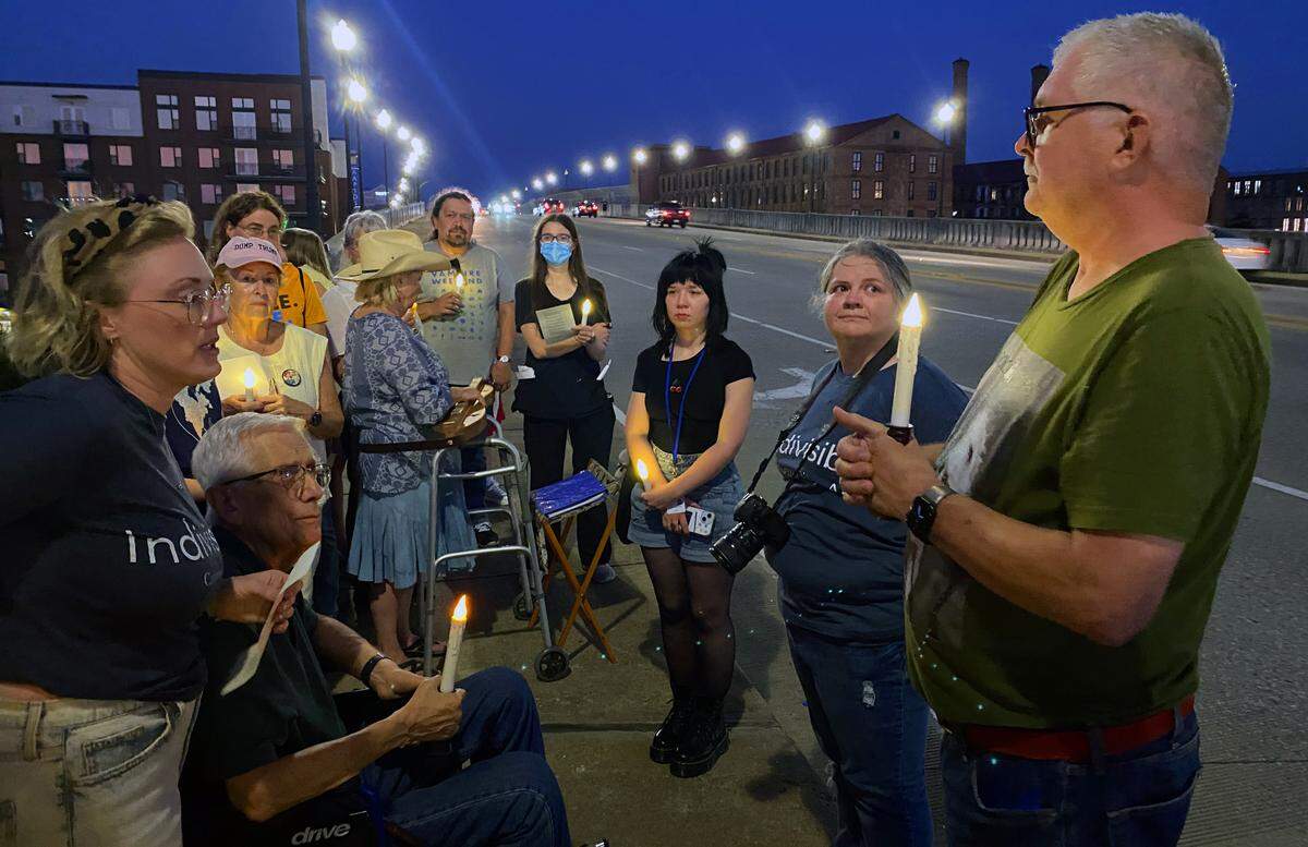 People gather Sept. 4, 2025, on the 13th Street Bridge, which connects Columbus, Georgia, to Phenix City, Alabama, for a candlelight vigil to remember and honor victims of gun violence. The event was organized by Phenix City Indivisible, Columbus, GA Indivisible and the Under the Muscadine Catholic Worker community.