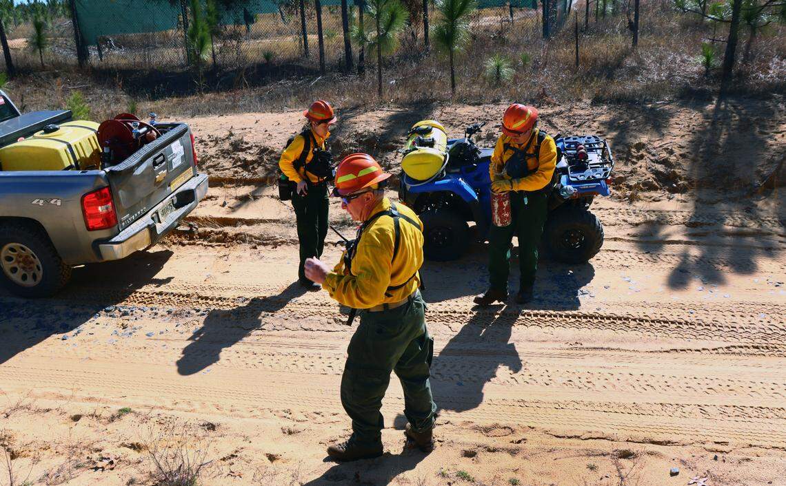 Hal Massie and Eli Carroll prep before they start to burn with the drip torch at Sand Hill Wildlife Management Area. Feb. 7, 2024.