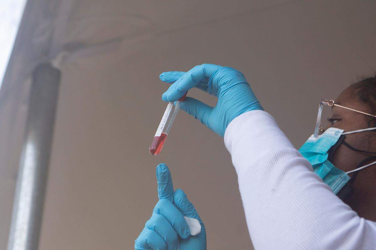 Physician Kynidee Brooks collects a swab during a drive-thru COVID-19 testing site at the Greater Ward Chapel AME Church in Columbus, Ga. on Jan. 10, 2022.