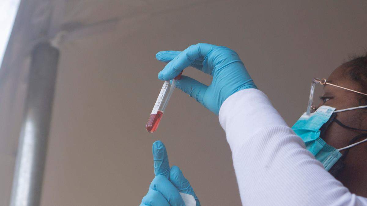 Physician Kynidee Brooks collects a swab during a drive-thru COVID-19 testing site at the Greater Ward Chapel AME Church in Columbus, Ga. on Jan. 10, 2022.