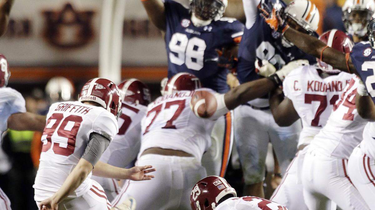 Alabama kicker Adam Griffith (99) attempts a 57-yard field goal attempt late in the second half of an NCAA college football game in Auburn, Ala., Saturday, Nov. 30, 2013. Griffith missed the kick, and Auburn's Chris Davis raced 100-plus yards for the winning score. Auburn won 34-28. (AP Photo/Dave Martin)
