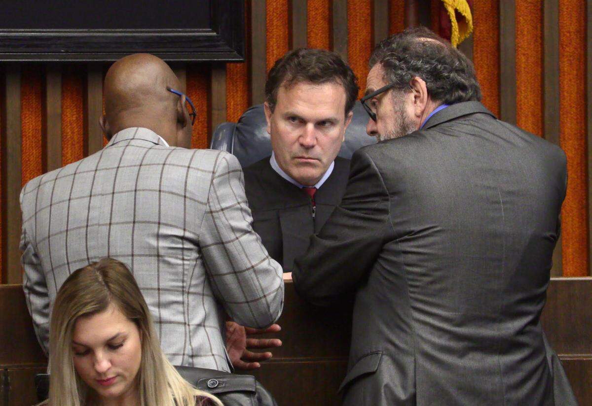 Left to right, District Attorney Stacey Jackson, Judge John Martin and public defender Steve Craft confer during Jayvon Hatchett’s assault trial.