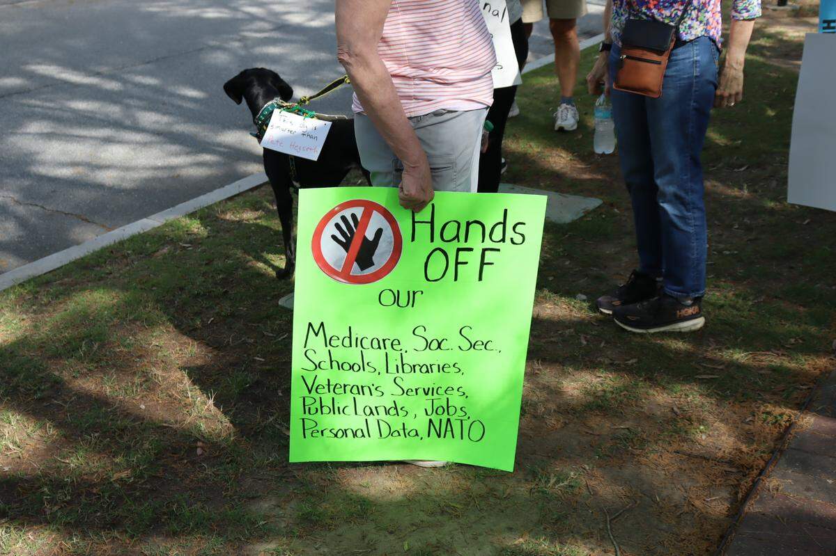 A protester holding a sign at the Hands Off protest in Columbus, 4/5/25 at 1000 Broadway Ave.
