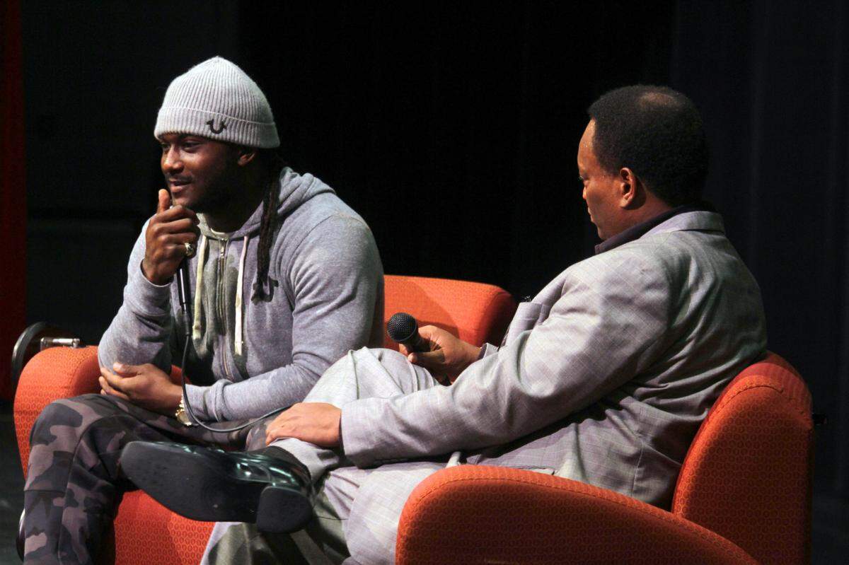 Former Carver standout running back Isaiah Crowell talks with DJ Jones during a tour of Crowell’s school system in 2014.