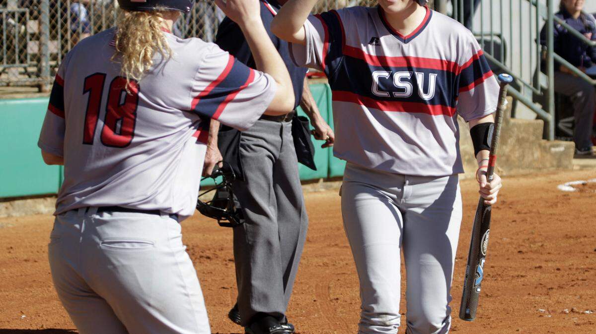 ROBIN TRIMARCHI rtrimarchi@ledger-enquirer.com 
 Columbus State's Rachel Rhodes, right, celebrates a run scored by Calli Star (18) in the season opener against the University of Alabama-Huntsville at South Commons Saturday. 01.31.16
