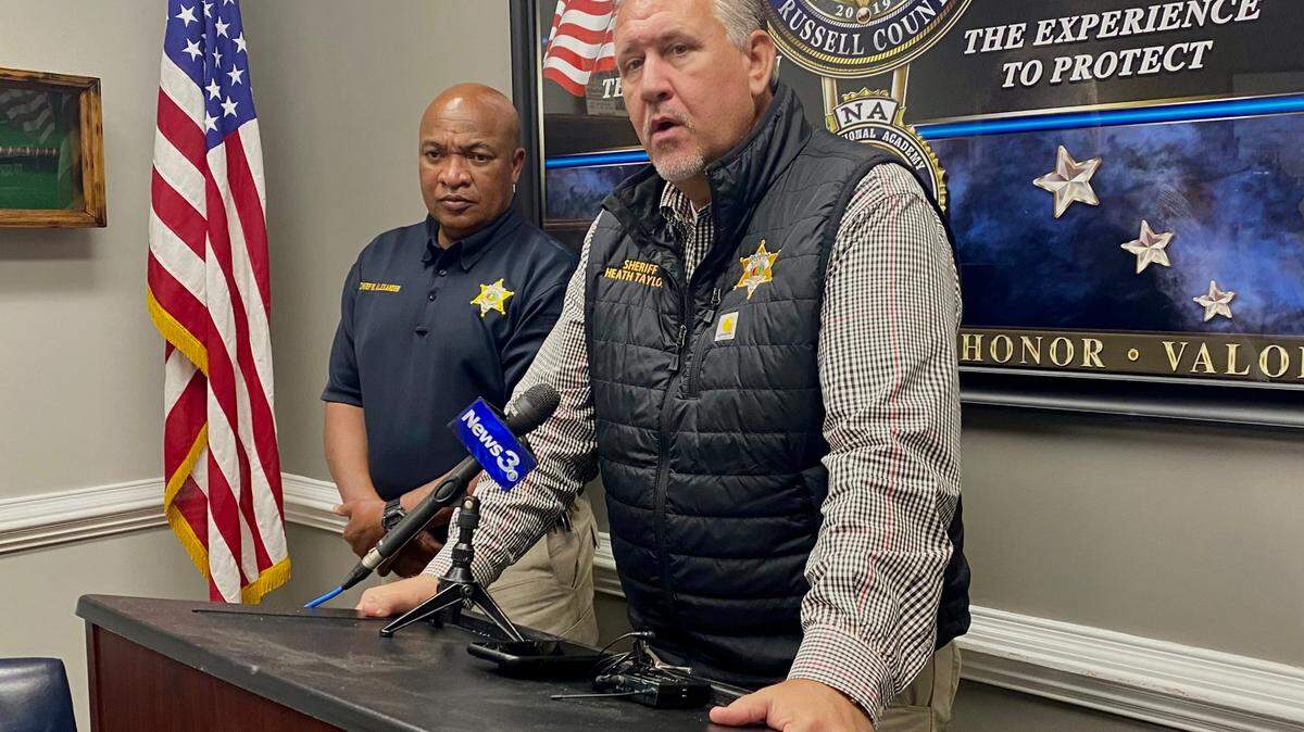 Russell County Sheriff Heath Taylor, center, answers questions during a Friday afternoon press conference at the Russell County Sheriff’s Office.