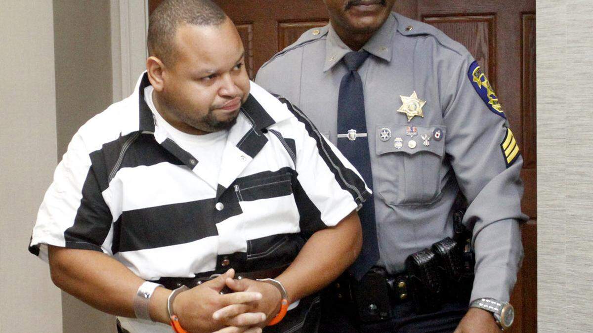 ROBIN TRIMARCHI rtrimarchi@ledger-enquirer.com
Christian Grissom is escorted out of court by a Russell County Sheriff's Department officer Friday morning. Grissom faces murder charges in the death of his second cousin Keonte Chavis. Davis' body was found near Seale, Alabama, on August 9, after having been missing for three days. Bond was set at one million dollars.  08.15.14