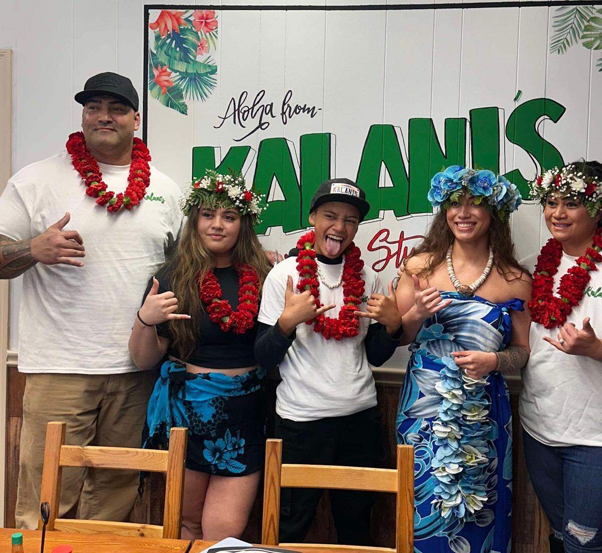 Kalani Sayles, owner of Kalani’s Hawaiian Style Cafe, 711 13th St. in Phenix City, is pictured on the right next to her family during her restaurant’s grand opening.