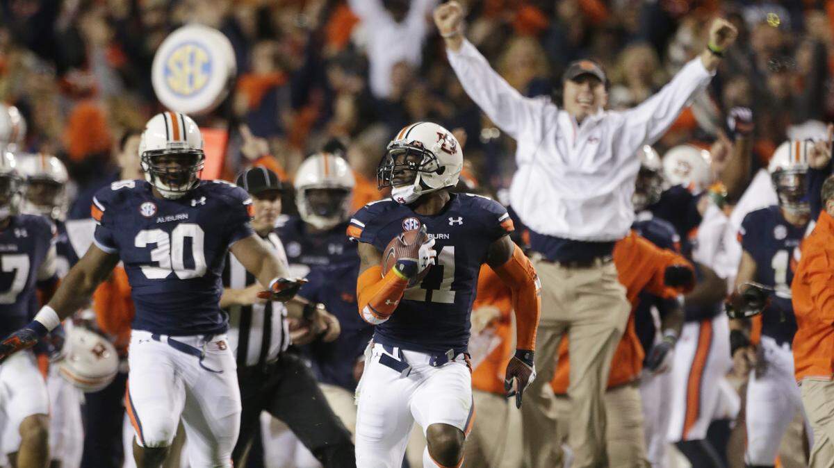 In this Nov. 30, 2013, file photo, Auburn cornerback Chris Davis (11) returns a field goal attempt 109-yards to score the winning touchdown over Alabama during the second half of an NCAA college football game in Auburn, Ala.