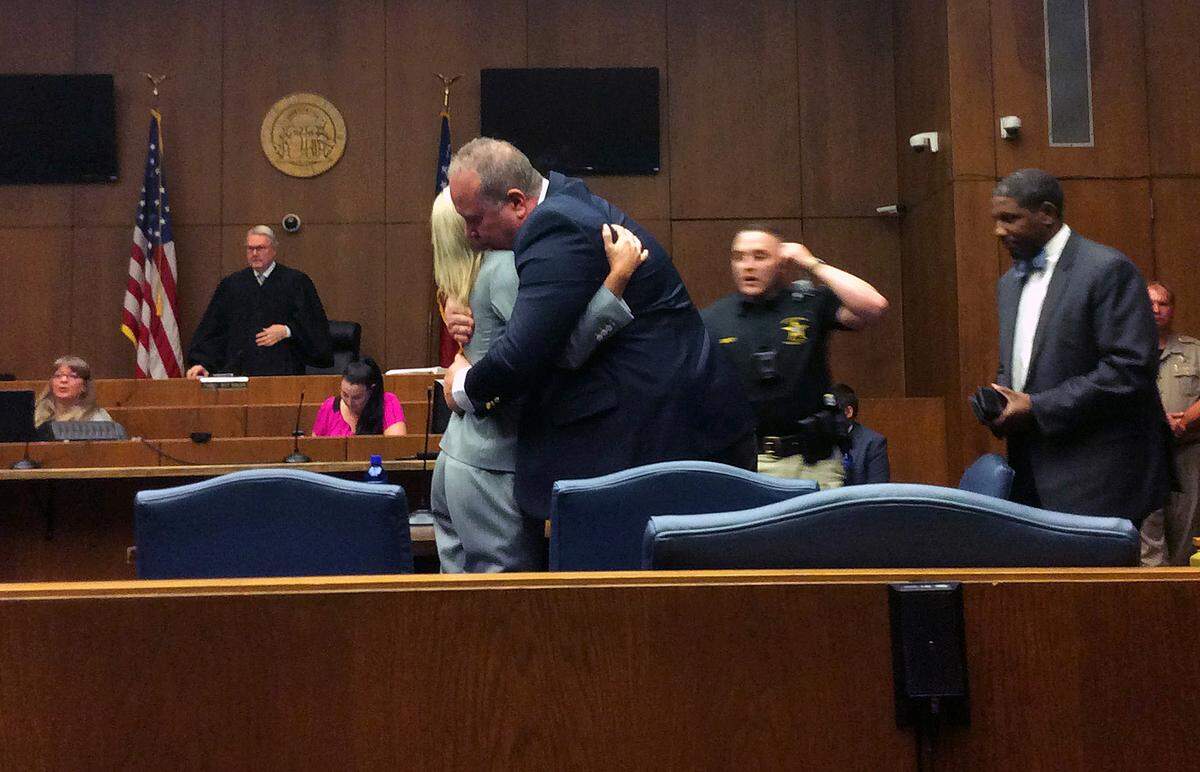 James Eric Perkins hugs defense co-counsel Jennifer Curry Friday afternoon after a jury found Perkins not guilty of involuntary manslaughter in the death of a customer fatally injured during a brawl outside Outlaws Saloon in north Columbus. Also representing Perkins at trial was co-counsel Barry Debrow.