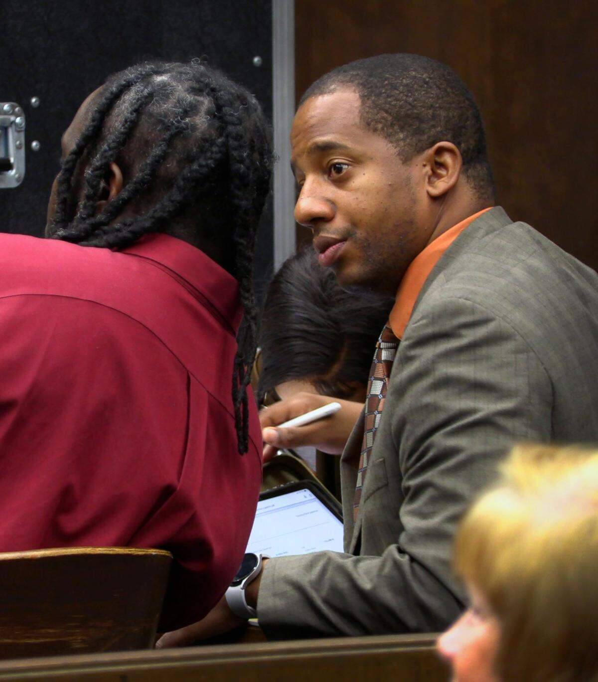 Defense attorney Anthony Johnson, right, speaks with his client Curtis “Baby C” Williams III during the trial Tuesday morning. 10/25/2022