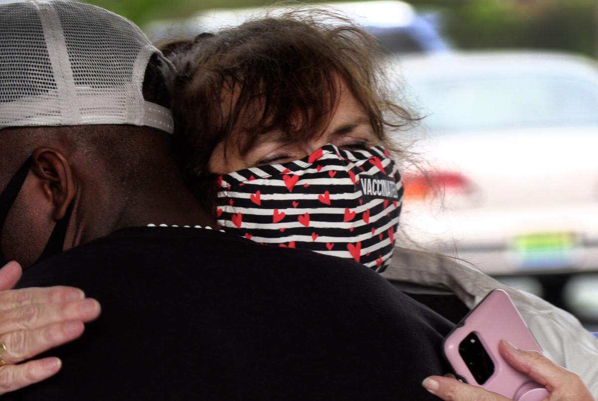 Rita Ellis of Paz Amigos hugs a man recently released from the Stewart Detention Center board a shuttle van at Groome Transportation in Columbus, Georgia on their way to Hartsfield-Jackson Atlanta International Airport.