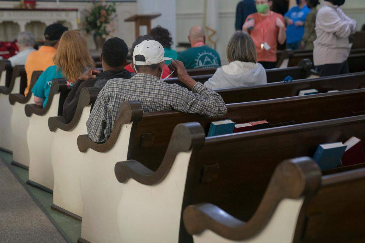 A man adjusts his mask while waiting for 15 minutes after receiving the Johnson & Johnson COVID-19 vaccine on Thursday, April 8, 2021 at Safehouse Ministries in Columbus, Ga.