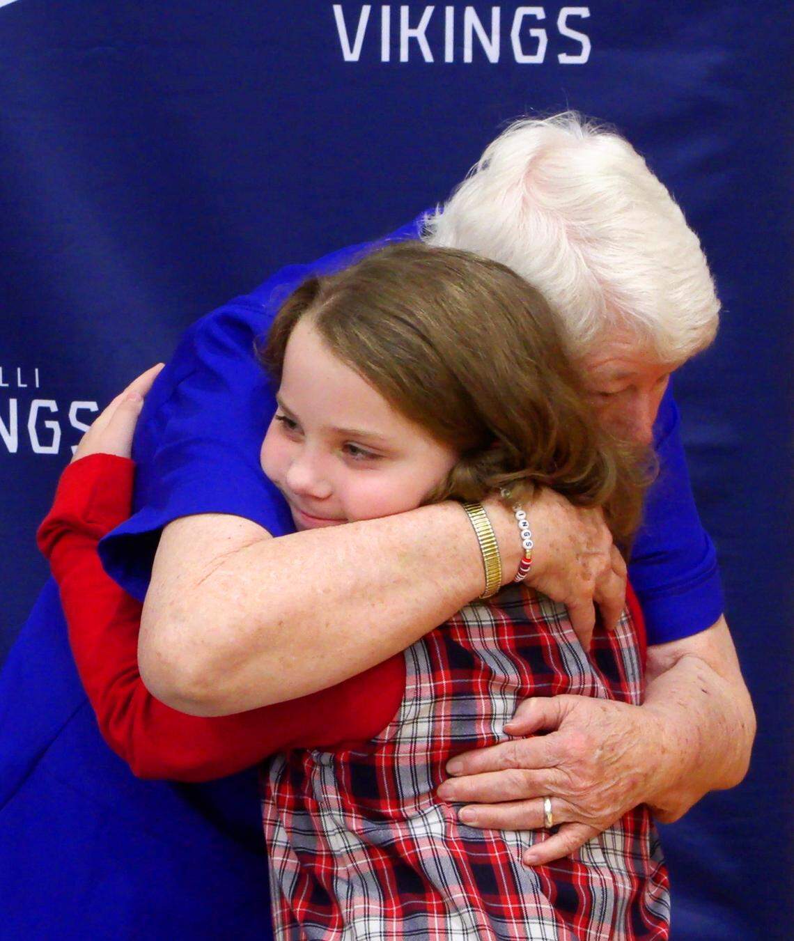 Sister Pat Thompson gets a hug from Emma Purdy, a third-grader at St. Anne-Pacelli Catholic School in Columbus, Georgia, at a Dec. 9, 2024, ceremony honoring Thompson and Sister Margaret Downing. Both are Sisters of Mercy and are retiring. 12/09/2024