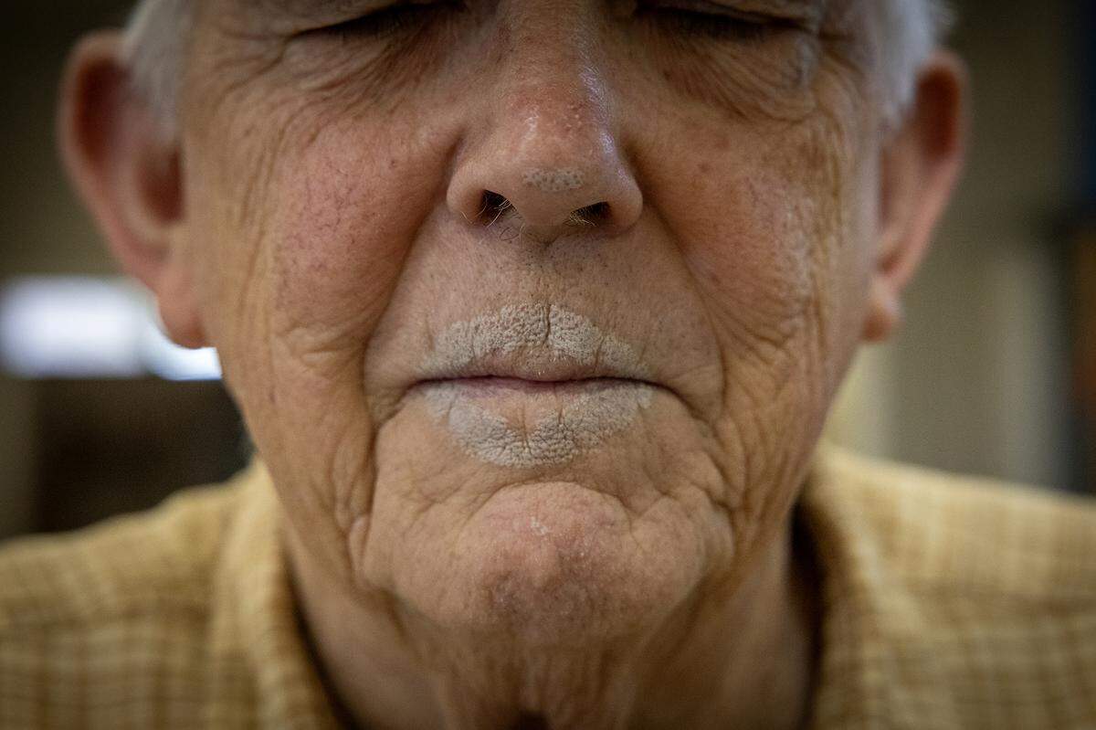 Folk potter Ned Berry ended up with clay on his face after blowing into a jug to help shape it while making pottery at Britt David Studio in Columbus on April 14, 2026.