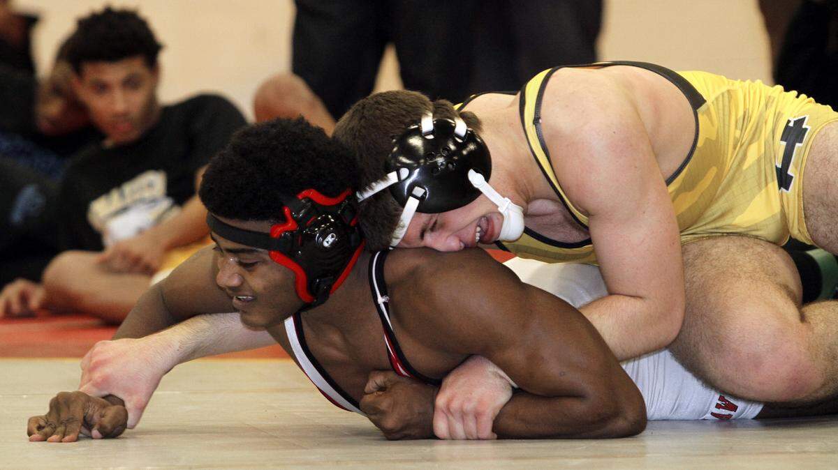 ROBIN TRIMARCHI rtrimarchi@ledger-enquirer.com 
 Harris County High's Matthew Coker, top, and Opelika High's Talik Jackson compete in the 82-pound weight class final during the Hardaway Invitational Wrestling Tournament Saturday at Hardaway High School. Coker won 9-7 in overtime. 12.19.15