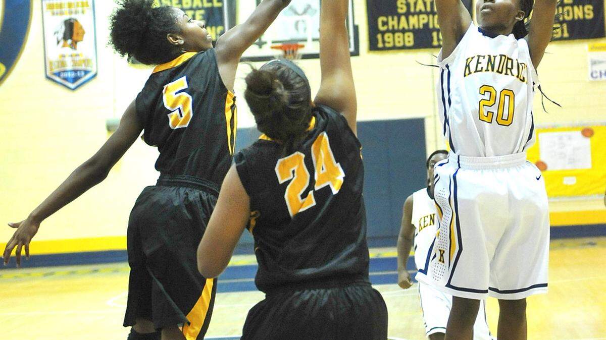 Kendrick's Destiny Murph shooting over Peach County's Jordan Davis and Eboni Steele Friday night during the Region 2 3A championship game play at Kendrick High School February 12, 2016