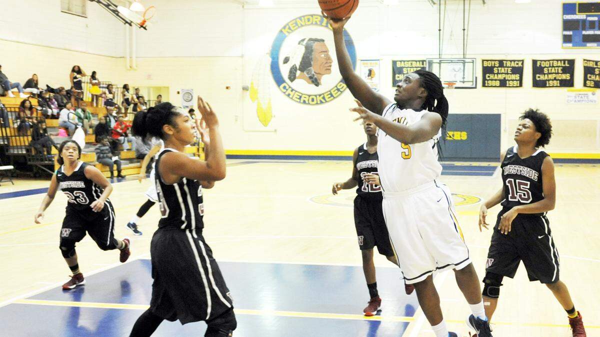 Kendrick's Raven Baker driving to the basket through several Westside players in the 1st half of the game Tuesday night at Kendrick High School