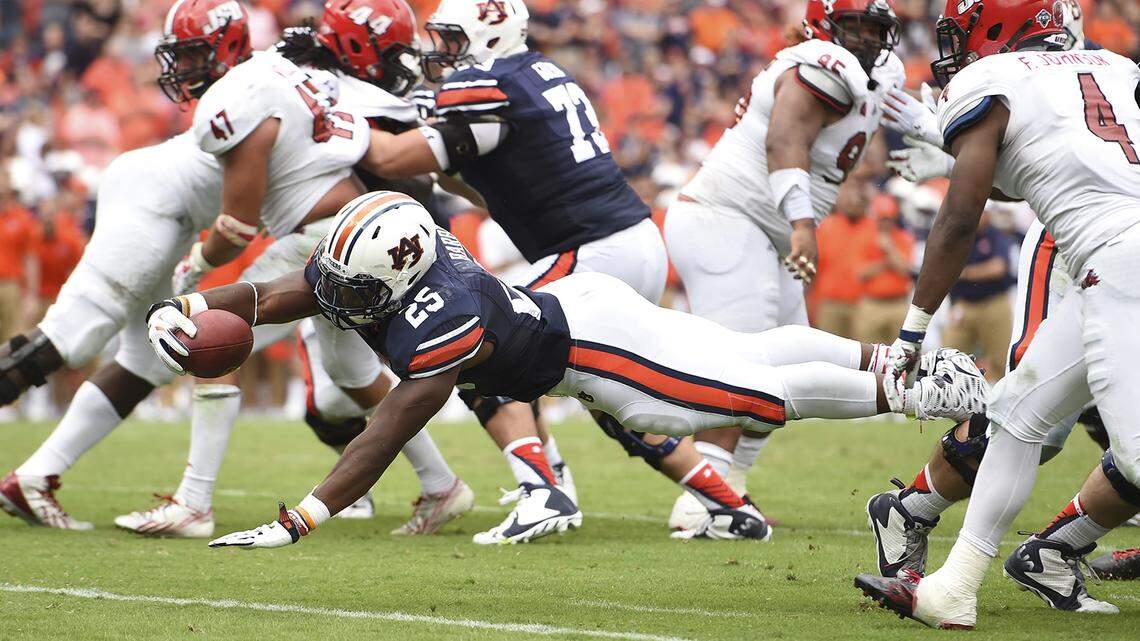Peyton Barber (25) dives into the endzone for the game-winning touchdown during overtime. Jacksonville State vs Auburn in Auburn, Ala. on Saturday, Sept. 12, 2015.Zach Bland/Auburn Athletics