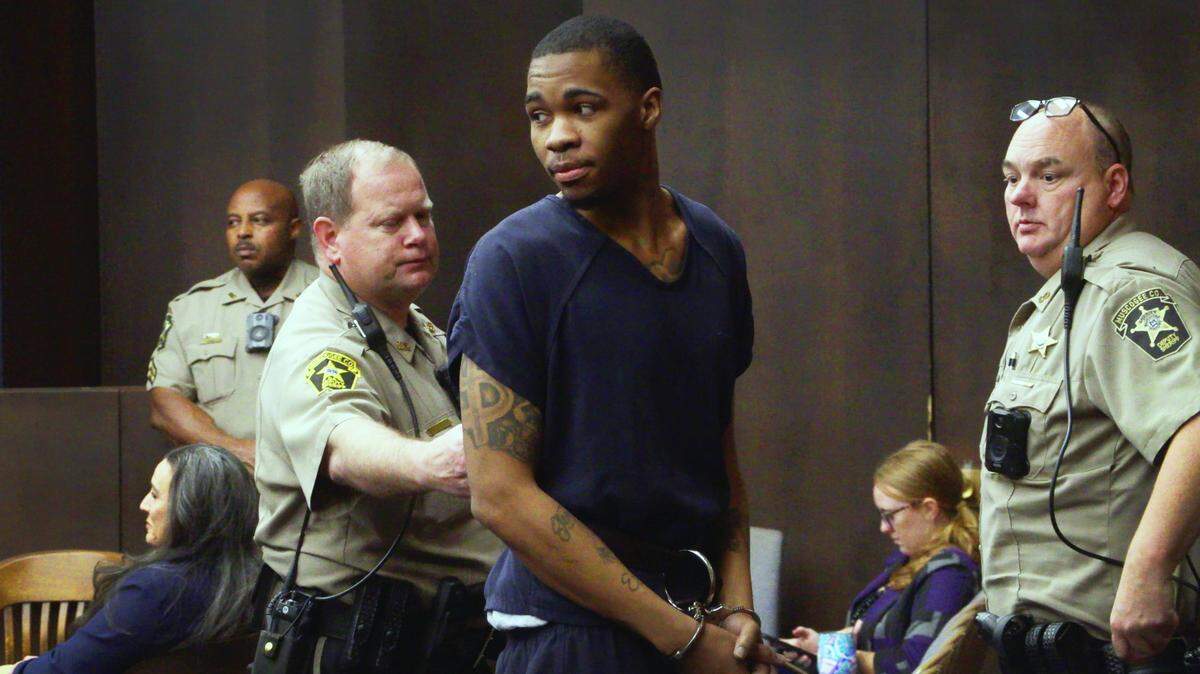 Anthony Nathan Foster, 26, center, is escorted from the courtroom Wednesday morning after receiving his sentence from Superior Court Judge John Martin. Foster pleaded guilty to home invasion, armed robbery, aggravated assault, false imprisonment and violating Georgia’s gang terrorism act. He was sentenced to 30 years in prison with 18 to serve and the rest on probation. 02/08/2023