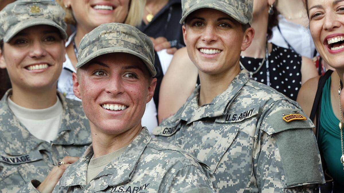 U.S. Army First Lt. Shaye Haver, center, and Capt. Kristen Griest, right, pose for photos with other female West Point alumni after an Army Ranger school graduation ceremony, Friday, Aug. 21, 2015, at Fort Benning, Ga. Haver and Griest became the Army's first female graduates of the Army's rigorous Ranger School, putting a spotlight on the debate over women in combat. (AP Photo/John Bazemore)
