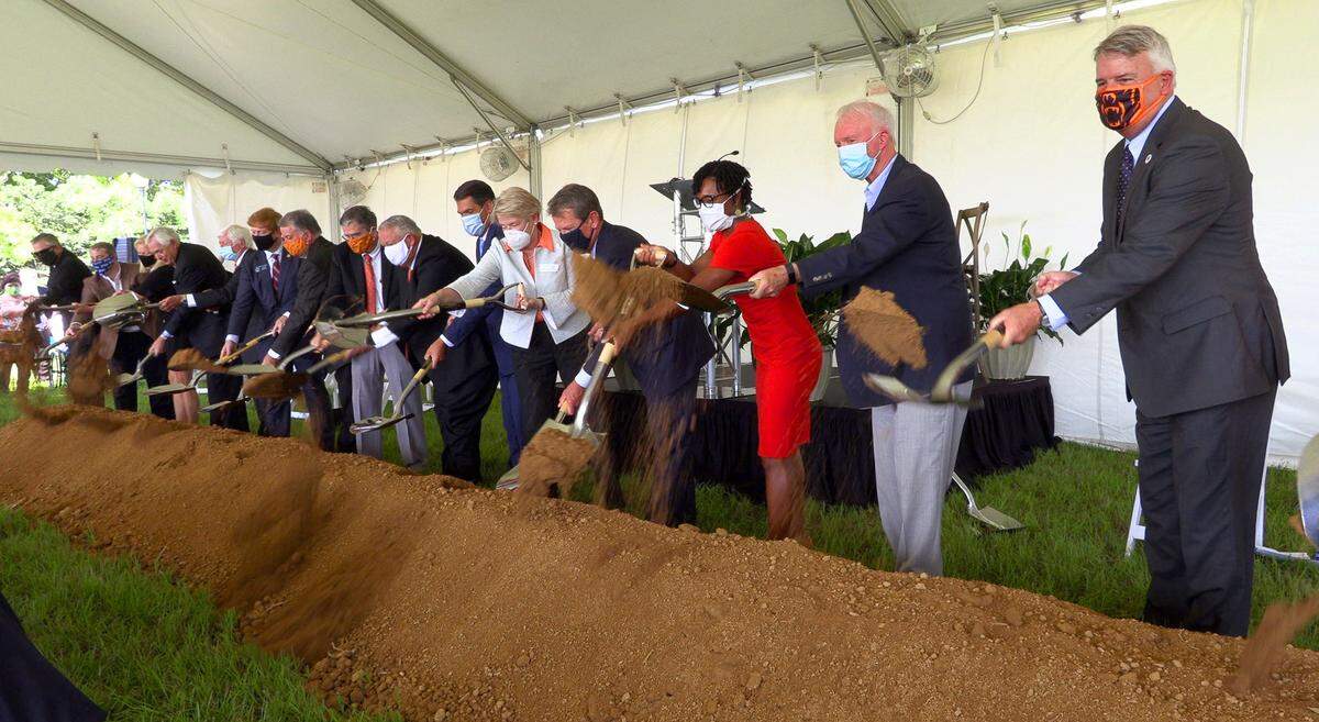 The first of three groups of dignitaries participate in a ceremonial turning of the earth Thursday morning during a ceremonial groundbreaking event for the Mercer University School of Medicine’s new campus in Columbus, Georgia.