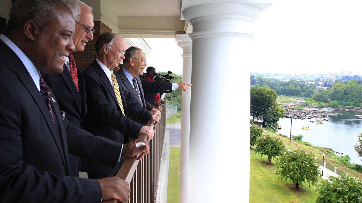 Mike Haskey mhaskey@ledger-enquirer.comFrom left, Phenix City Mayor Eddie Lowe, Troy University Chancellor Jack Hawkins Jr., Alabama Gov. Robert J. Bentley, and David White, vice chancellor of Troy University's Phenix City campus, look from a fourth-floor balcony as rafters on the Chattahoochee River drift downstream. 09/11/15
