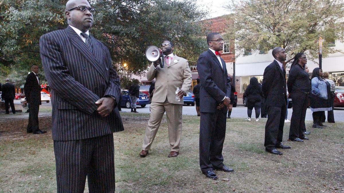 ROBIN TRIMARCHI/rtrimarchi@ledger-enquirer.comMinister Antonio Carter calls out for social justice in the Zikarious "Snoop" Flint case during a gathering of the National Joshua Generation Empowerment Movement, the Nation of Islam, Women of Vision and the Local Organizing Committee in front of the Columbus State University downtown police precinct Saturday. The National Joshua Generation Empowerment Movement is a self-improvement organization with the mission of making leaders, producers and providers of men in the community.