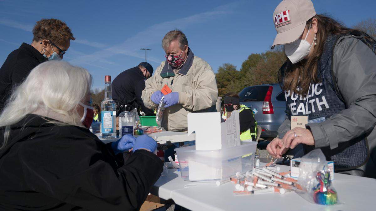Department of Public Health staff prepare syringes of the Moderna COVID-19 vaccine at the Civic Center in Columbus, Ga. on Saturday, Jan. 23, 2021.